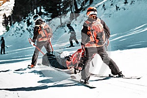 Rescuers at a ski resort evacuate the victim from the slope.