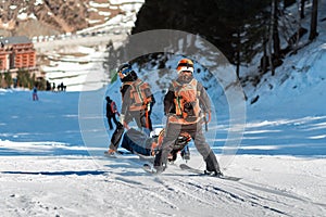 Rescuers at a ski resort evacuate the victim from the slope.