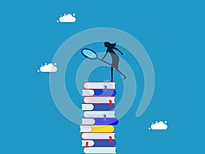 Research and gather information. woman using a magnifying glass on a tall stack of books