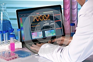 Research geneticist using computer biotechnology lab