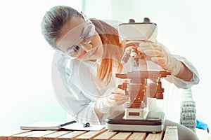 Research scientist looking bacteria through a microscope in laboratory room, Science, chemistry, technology, biology