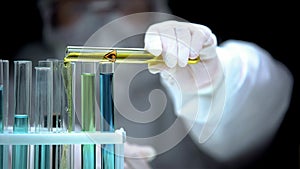 Researcher adding liquid from test tube with fire symbol, warning sign, danger