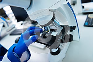 Researcher conducting his research using a microscope