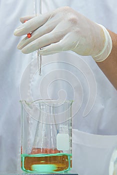 Researcher doing the experiment, titration of the reagent in the photo