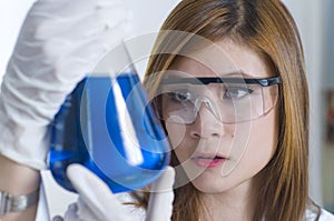 Researcher examining chemicals in a laboratory