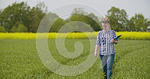 Researcher Examining Crops While Writing In Clipboard