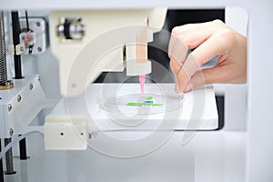 Researcher getting 3D bioprinter ready to 3D print cells onto an electrode