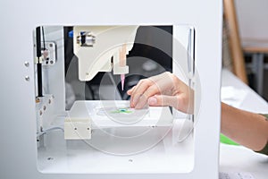 Researcher getting 3D bioprinter ready to 3D print cells onto an electrode