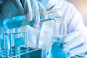Researcher with glass laboratory chemical test tubes with liquid