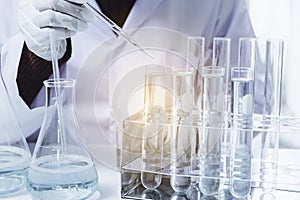 Researcher with glass laboratory chemical test tubes with liquid for analytical , medical, pharmaceutical and scientific research