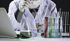 Researcher with glass laboratory chemical test tubes with liquid for analytical , medical, pharmaceutical and scientific research