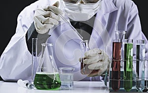 Researcher with glass laboratory chemical test tubes with liquid for analytical , medical, pharmaceutical and scientific research