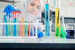 Researcher with glass laboratory chemical test tubes with liquid for analytical , medical, pharmaceutical and scientific research