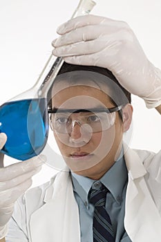 Researcher holding flask with chemicals