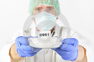 Researcher holding sweetener E951