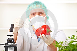 Researcher holding up a GMO vegetable