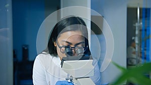 Scientist using a microscope