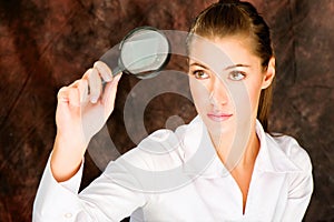 Researcher looking through magnifier glass