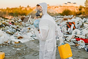 Researcher looking at plastic landfill analyzing environmental pollution level