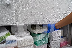 The researcher opens the storage box that keeps the sample in -80C refrigerator. To finds samples of protein used for the further