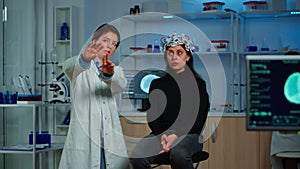 Researcher and patient with eeg headset looking at virtual display