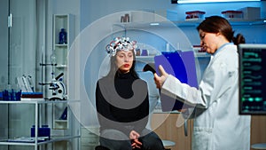 Researcher pointing at clipboard explaning treatment against brain disease