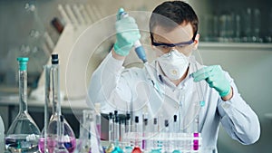 Researcher with tube and dropper in the modern lab