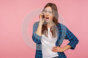 Resentful upset astonished girl calling to friend complaining about life with vexed expression