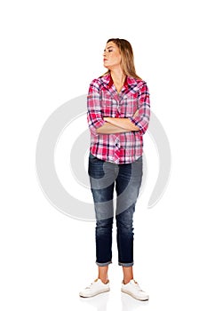 Resentful young woman with folded hands photo