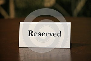 Reservation card on wooden table. photo