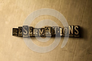 RESERVATIONS - close-up of grungy vintage typeset word on metal backdrop photo