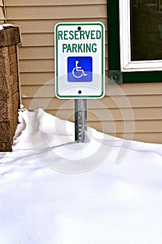 Reserved Parking Handicapped sign in a snow bank