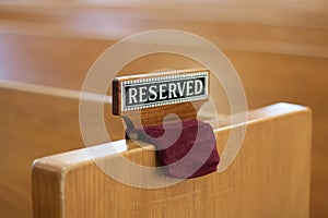 Reserved sign on church pew photo