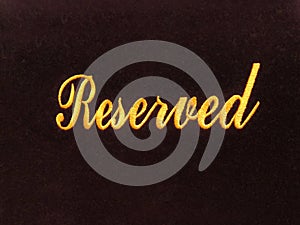 Reserved sign on dark background / reservation concept in restaurant