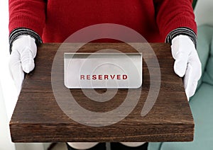 Reserved sign, reservation. On table.