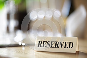 Reserved sign on restaurant table photo