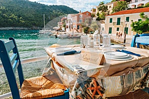 Reserved table in Greek tavern in Assos fishing village, Kefalonia island, Greece