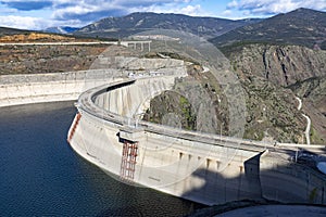 Reservoir. Prey. Dam located in the Atazar, north of the Community of Madrid. Damned water next to some green and pink mountains.