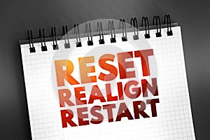 Reset Realign Restart text quote on notepad, concept background photo