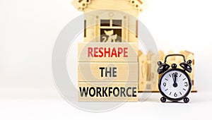 Reshape the workforce and support symbol. Concept words Reshape the workforce on blocks. Black alarm clock. Beautiful white table