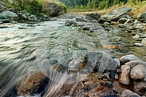 Reshi River water flowing on rocks at dawn, Sikkim, India photo