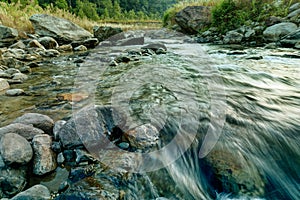 Reshi River water flowing on rocks at dawn, Sikkim, India photo