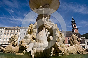 The Residence fountain with the St. Michael`s church in Salzburg