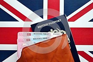 Residence Permit BRP card and British Passport of United Kingdom on Union Jack flag