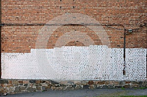 Residental house wall with white paint patches covering graffiti vandalism