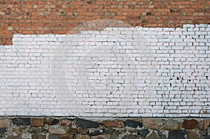 Residental house wall with white paint patches covering graffiti vandalism