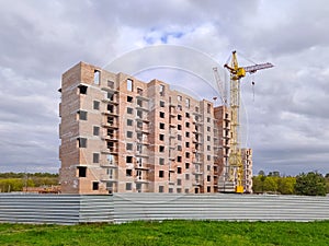 Residential house under construction and crane.