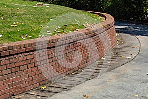 Residential brick retaining wall, curved along driveway