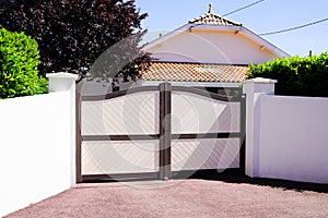 Residential brown sandy portal home suburb metal aluminum house gate street wall