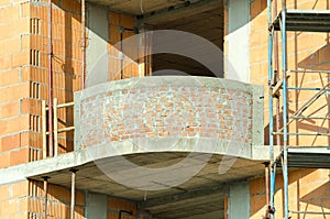 Residential building construction site close up of apartment brick terrace balcony .